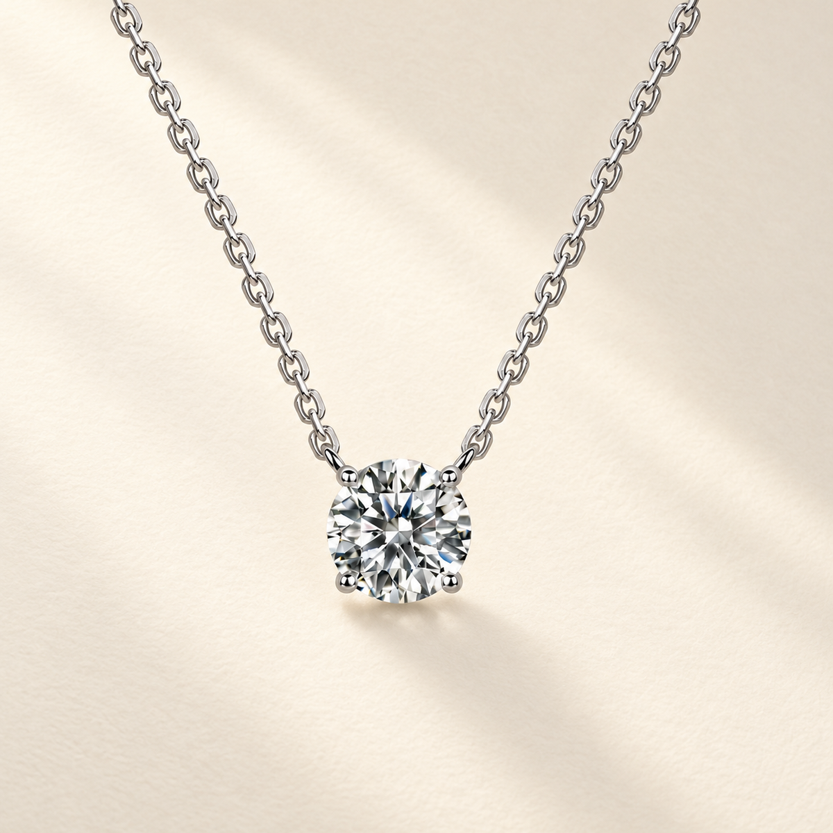 Silver moissanite solitaire necklace on a warm ivory background