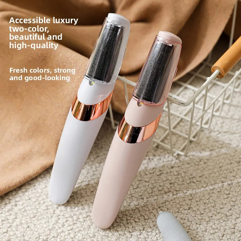 Two electric foot grinder with rose gold accents on a textured surface.